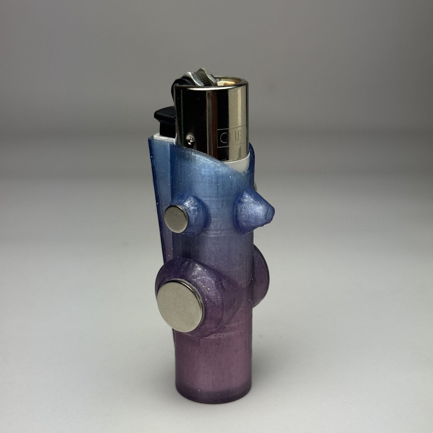 Purple lighter with metallic accents on a gray background